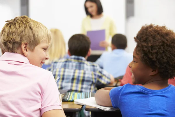 Two Pupils Talking In Class Together Stock Picture