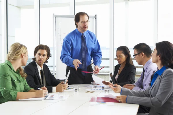 Businesswoman Conducting Meeting In Boardroom Stock Picture