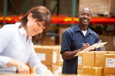Workers In Warehouse Preparing Goods For Dispatch clipart