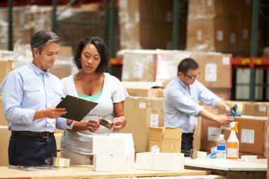 Workers In Warehouse Preparing Goods For Dispatch clipart