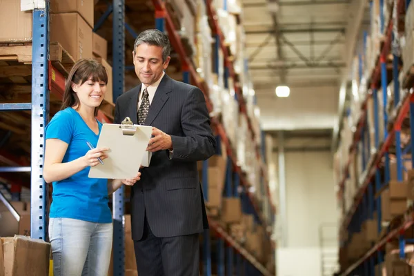 Businessman And Female Worker In Distribution Warehouse — Stock Photo, Image