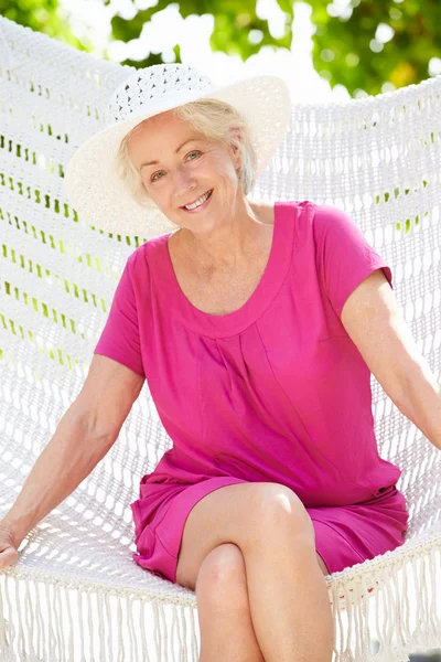 Senior Woman Relaxing In Beach Hammock Stock Image