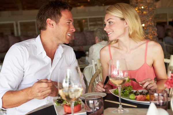 Couple Enjoying Meal In Restaurant Stock Image