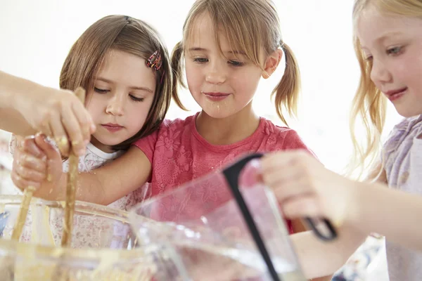 Tre flickor att göra cupcakes i köket — Stockfoto