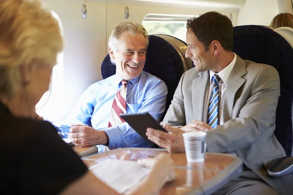 Businesspeople traveling by train — Stock Photo, Image