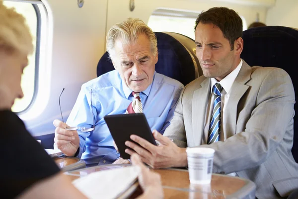 Businesspeople traveling by train — Stock Photo, Image