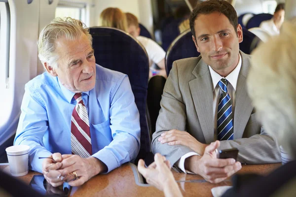 Businesspeople traveling by train — Stock Photo, Image