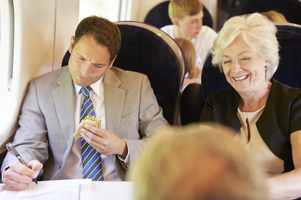 Businesspeople traveling by train — Stock Photo, Image