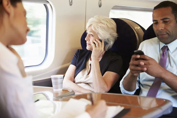 Businesspeople traveling by train — Stock Photo, Image