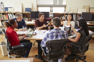 Group Of Architects Meeting Around Desk clipart
