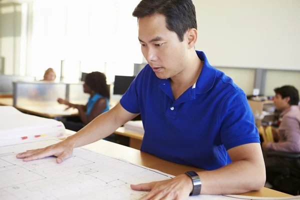 Male Architect Studying Plans In Office — Stock Photo, Image