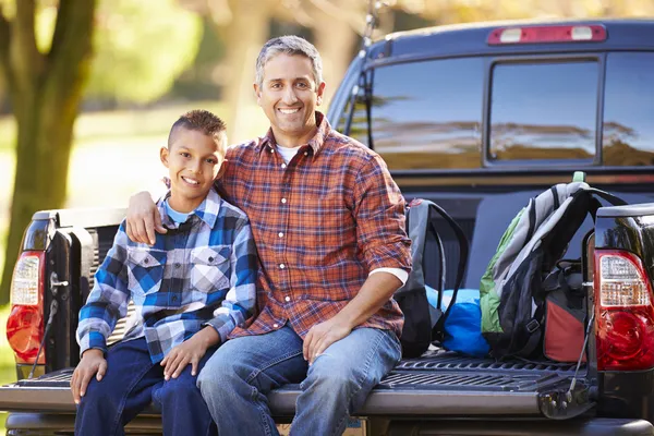 Father And Son Sitting In Pick Up Truck On Camping Holiday — Stock Photo, Image