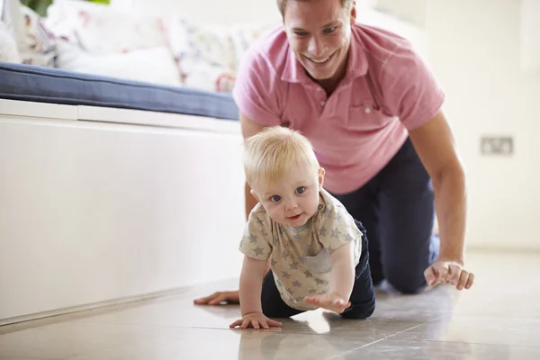 Father And Young Son Crawling Stock Picture