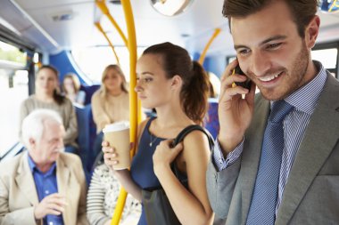 Passengers Standing On Busy Commuter Bus clipart