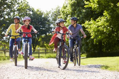 Hispanic Family On Cycle Ride In Countryside clipart