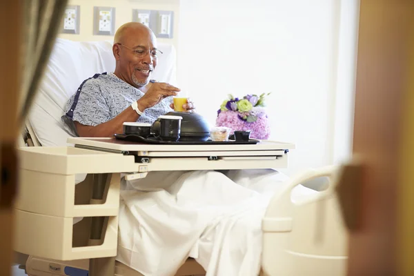 Senior Male Patient Enjoying Meal In Hospital Bed — Stock Photo, Image