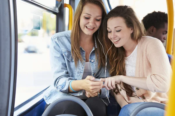 Two Young Women Listening To Music On Bus — Stock Photo, Image