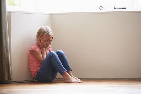 Unhappy Child Sitting On Floor In Corner At Home — Stock Photo, Image