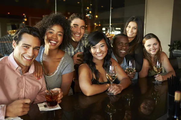 Group Of Friends Enjoying Drink At Bar Together Royalty Free Stock Photos