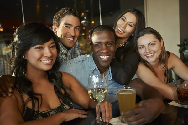 Group Of Friends Enjoying Drink At Bar Together Stock Picture