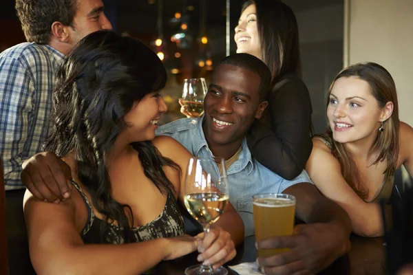 Group Of Friends Enjoying Drink At Bar Together Royalty Free Stock Photos