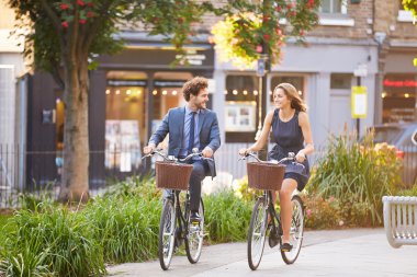 Couple Riding Bike in City Park clipart