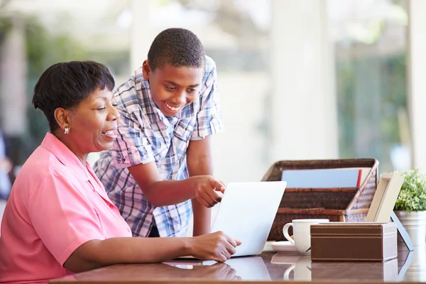 Pojke att hjälpa mormor med laptop — Stockfoto