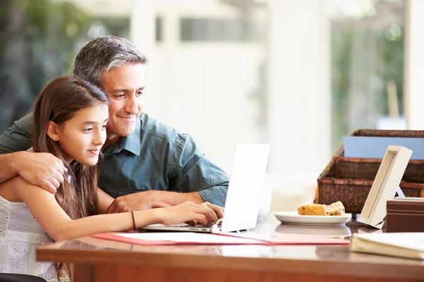 Ojciec pomoc córki patrząc na laptopa — Zdjęcie stockowe