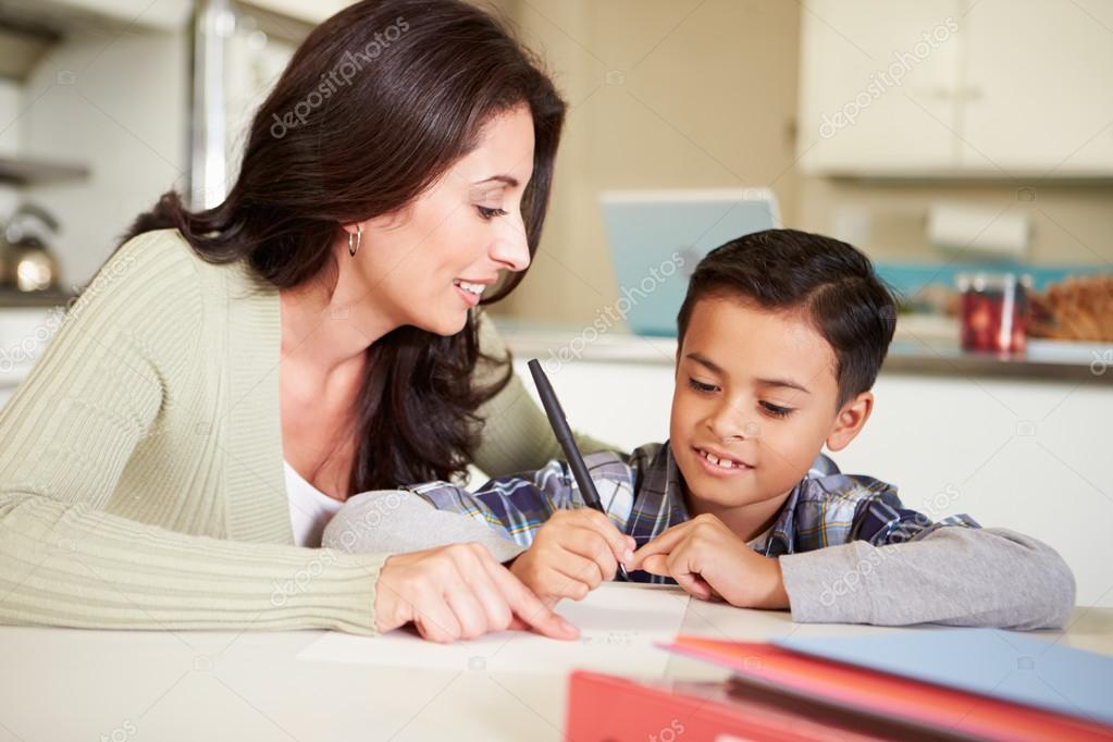 Hispanic Mother Helping Son With Homework At Table Stock Photo By C Monkeybusiness
