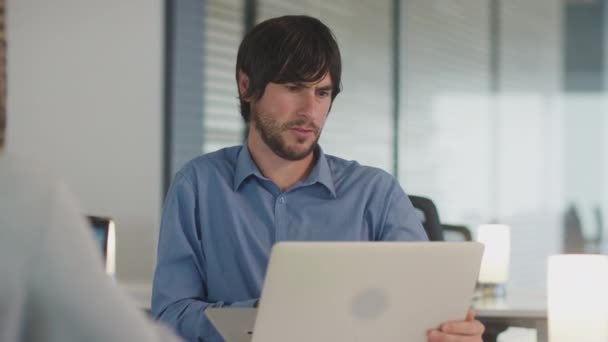 Two Businessmen Working Desks Laptops Discussing Document Screen Modern Office — 图库视频影像