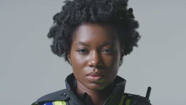 Studio Portret Van Ernstige Jonge Vrouwelijke Politieagent Tegen Platte Achtergrond — Stockvideo
