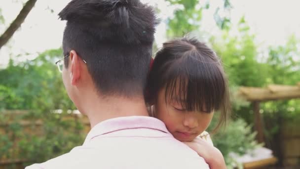 Loving Asian Father Cuddling Daughter Garden Girl Looks His Shoulder — Stock Video