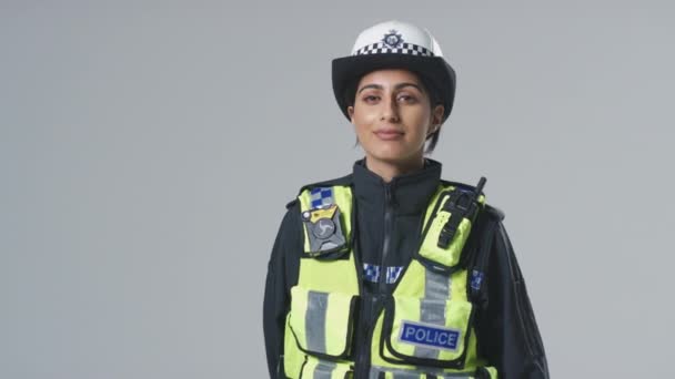 Studio Πορτρέτο Του Χαμογελώντας Νεαρή Γυναίκα Αστυνομικός Σχέση Απλό Υπόβαθρο — Αρχείο Βίντεο