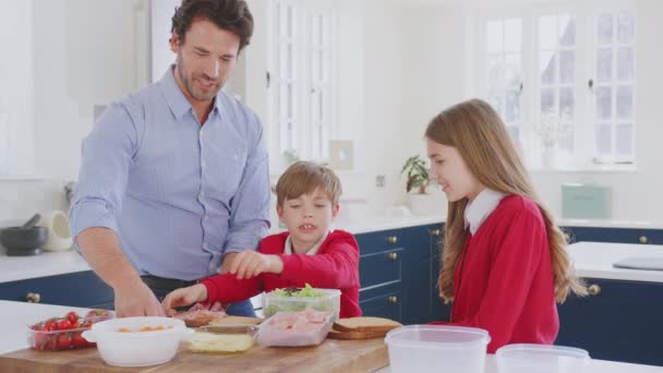 Father Helping Children Wearing School Uniform Make Healthy Sandwich Packed — Stock Video