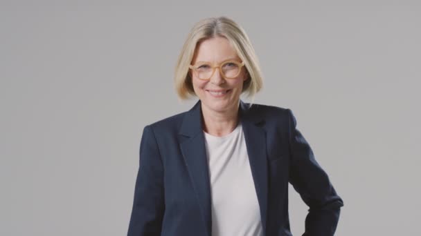 Studio Portrait Smiling Mature Businesswoman Wearing Glasses Plain Background — Stock Video