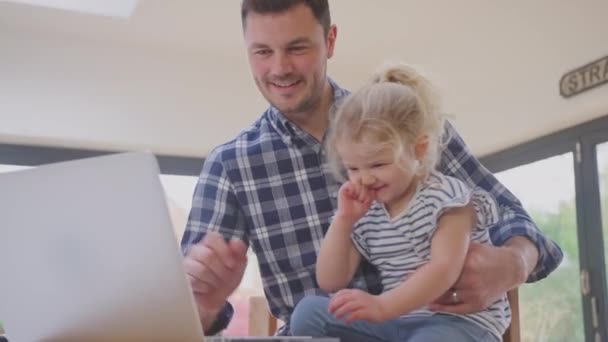 Working Father Using Laptop Home Kitchen Counter Whilst Looking Young — Stock Video