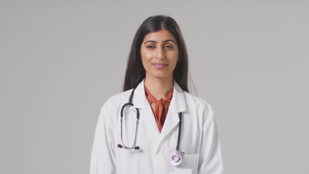 Portrait Smiling Female Doctor Stethoscope Wearing White Coat Plain Background — Stock Video