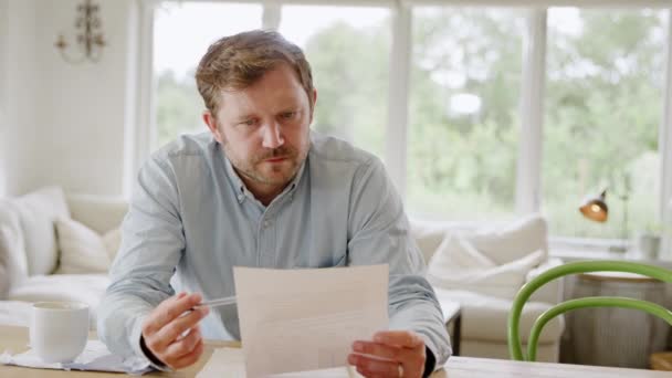 Worried Man Sitting Table Home Reviewing Domestic Finances Looking Bill — Stock Video
