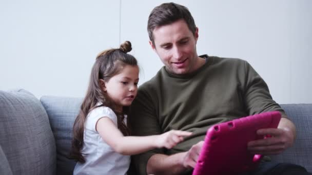 Father Daughter Sitting Sofa Home Playing Computer Game Together Digital — 图库视频影像