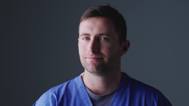 Studio Portrait Male Nurse Wearing Scrubs Grey Background Shot Slow — Stock Video