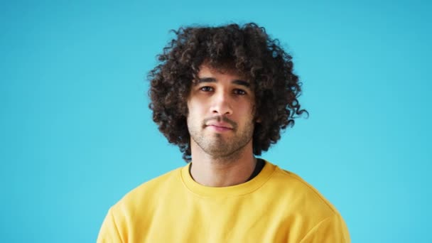 Studio Portrait Confident Young Man Looking Camera Neutral Expression Folded — Stock Video