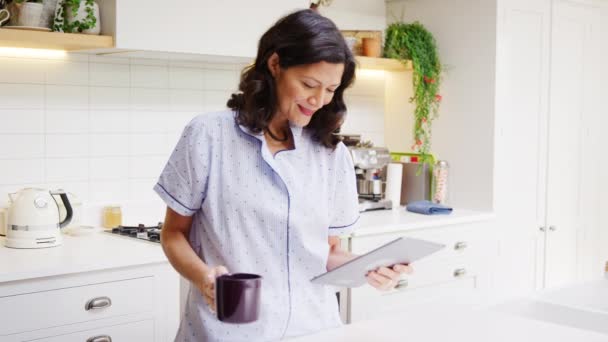 Mature Woman Home Kitchen Wearing Pyjamas Looking Digital Tablet Shot — 图库视频影像