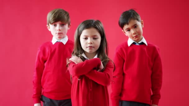 Group Elementary School Pupils Wearing Uniform Folding Arms Red Studio — 图库视频影像