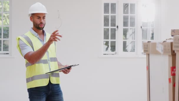 Builder Wearing Hard Hat Clipboard Checking Delivery New Kitchen Units — Stock Video