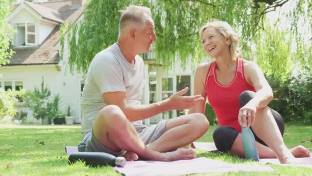 Senior Couple Home Garden Wearing Fitness Clothing Relaxing Chatting Outdoor — Stock Video