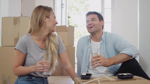 Couple Taking Break Moving Day Sitting Floor Drinking Champagne Surrounded — Stock Video