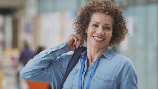 Portrait Smiling Mature Female Teacher Student Backpack College Hall Shot — Stockvideo