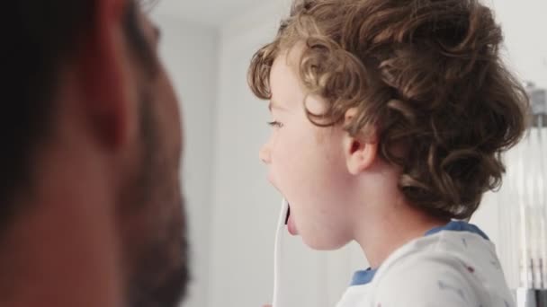 Close Father Helping Young Son Brush Teeth Bathroom Shot Slow — Stock Video