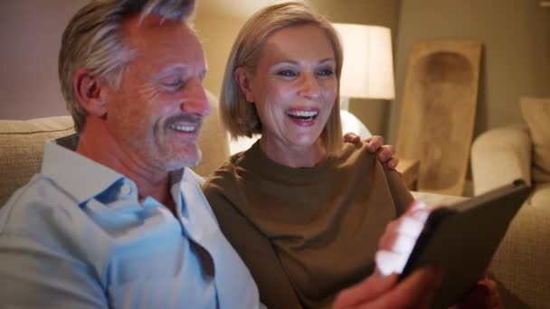 Mature Couple Home Evening Shopping Online Digital Tablet Shot Slow — Stockvideo