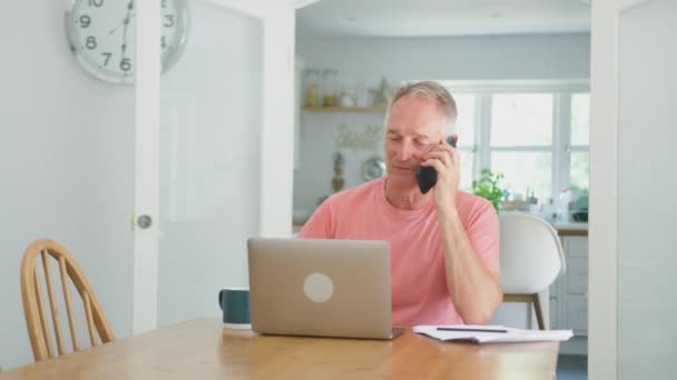 Sorrindo Aposentado Homem Idoso Telefone Casa Cozinha Usando Laptop Filmado — Vídeo de Stock